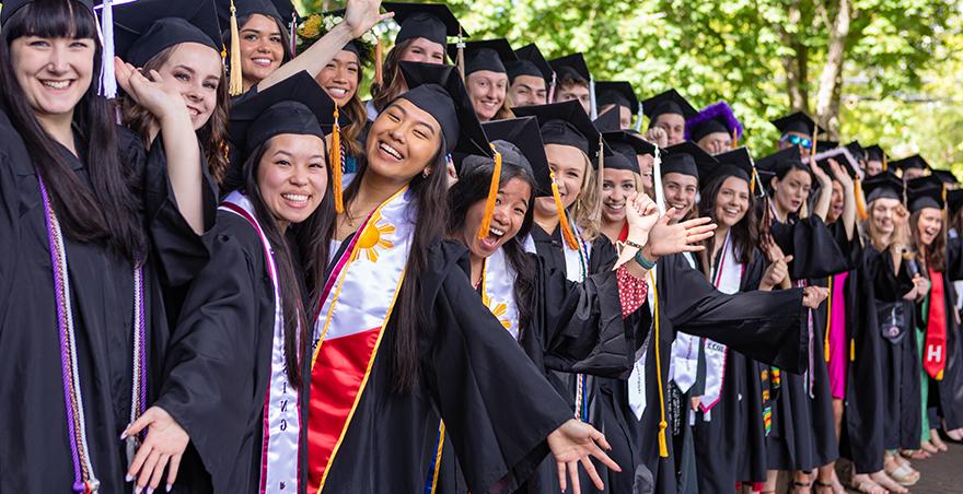 Excited students in their caps and gowns wait for SPU